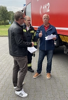 112 - Muss das sein? Dreharbeiten mit Sven Dammann, Rolf Mau und Thomas Waldner 3 Personen stehen vor einem Feuerwehrauto